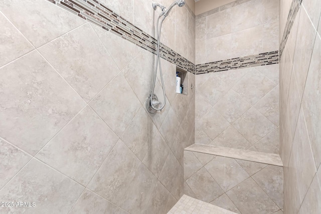 interior details featuring a tile shower