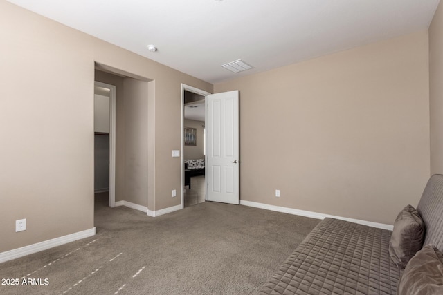 unfurnished bedroom featuring visible vents, baseboards, and carpet flooring