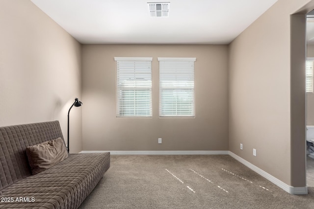 living area with carpet floors, baseboards, and visible vents