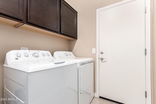 laundry room with light tile patterned flooring, cabinet space, and separate washer and dryer