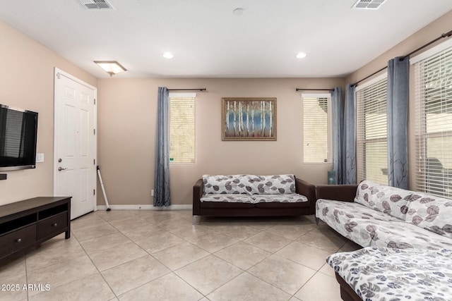 living room featuring light tile patterned floors, baseboards, and recessed lighting