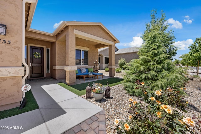 6135 E Livingston Loop, Prescott Valley, AZ 86314 - entrance to property featuring stucco siding, outdoor lounge area, and a patio area