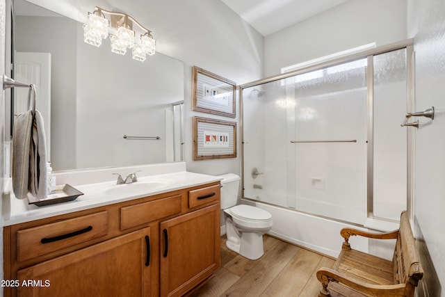 6135 E Livingston Loop, Prescott Valley, AZ 86314 - full bath featuring toilet, wood finished floors, vanity, and bath / shower combo with glass door