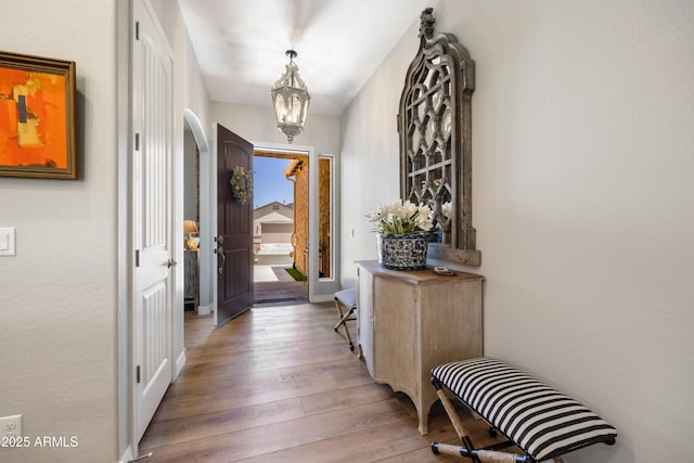 6135 E Livingston Loop, Prescott Valley, AZ 86314 - entryway with wood finished floors, a chandelier, and arched walkways