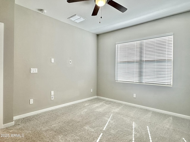 carpeted spare room with ceiling fan