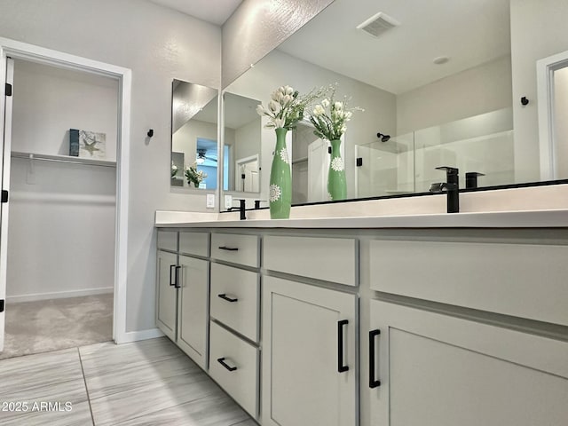 bathroom with a shower and vanity