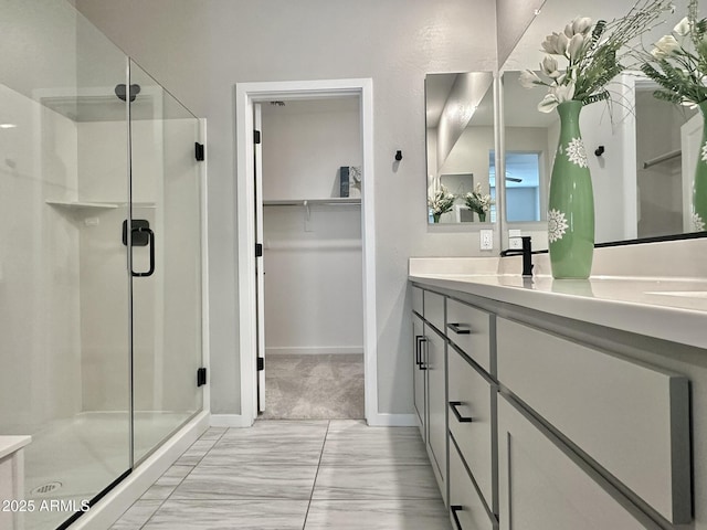 bathroom featuring vanity and an enclosed shower