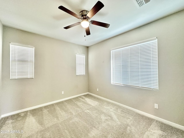 carpeted empty room featuring ceiling fan