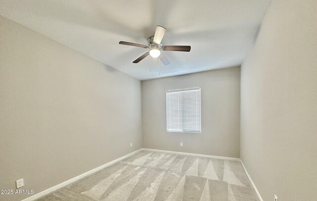 unfurnished room with ceiling fan and light carpet