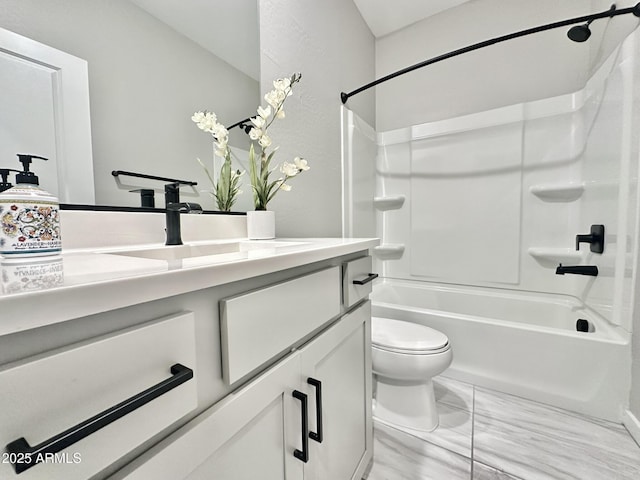 full bathroom featuring toilet, vanity, and  shower combination