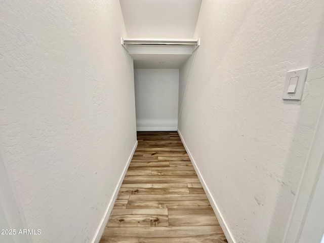 hallway featuring wood-type flooring