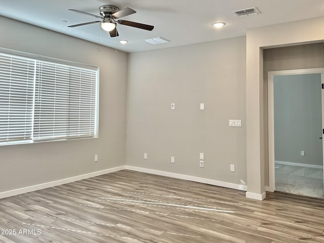 empty room featuring light hardwood / wood-style flooring and ceiling fan