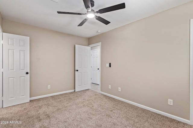 unfurnished bedroom featuring ceiling fan and light carpet