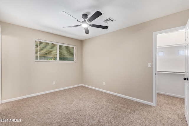 unfurnished room featuring ceiling fan and light carpet