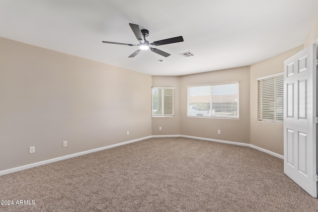 spare room featuring carpet flooring and ceiling fan