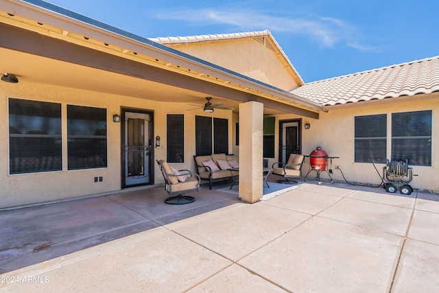 exterior space with an outdoor living space, ceiling fan, and a patio