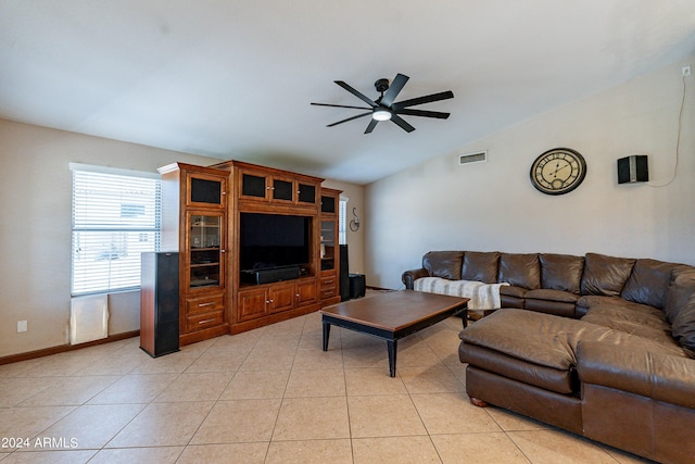 tiled living room featuring ceiling fan and lofted ceiling