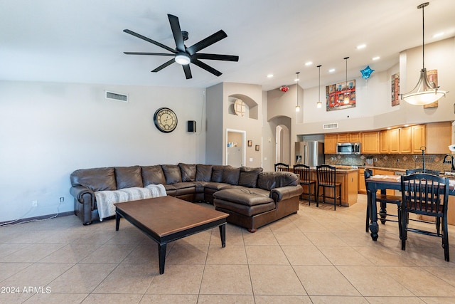 living room with ceiling fan, light tile patterned floors, and high vaulted ceiling