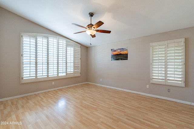 empty room with light wood-type flooring, vaulted ceiling, and ceiling fan