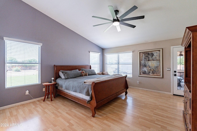 bedroom featuring ceiling fan, light hardwood / wood-style floors, access to exterior, and vaulted ceiling