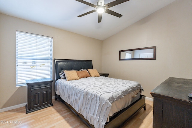 bedroom featuring light wood-type flooring, ceiling fan, and lofted ceiling