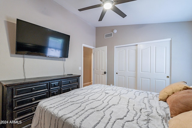 bedroom with ceiling fan, a closet, and lofted ceiling