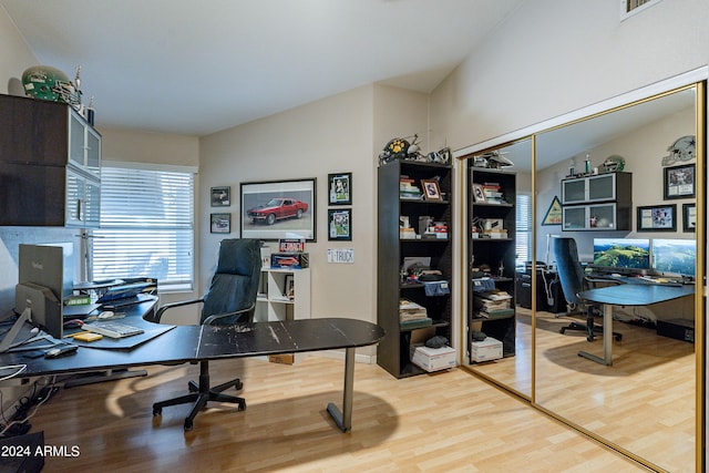 office featuring wood-type flooring and lofted ceiling