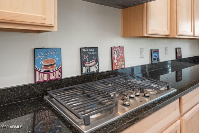 room details with stainless steel gas stovetop and light brown cabinetry