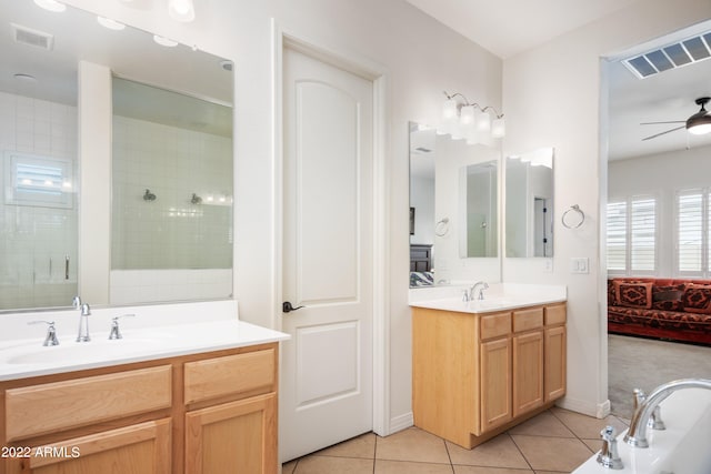 bathroom with tile patterned floors, ceiling fan, vanity, and tiled shower