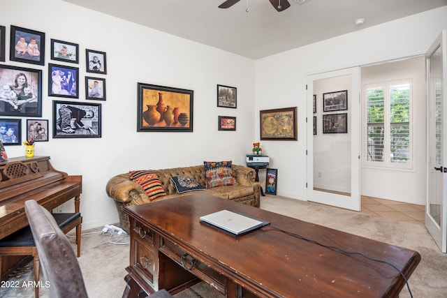 carpeted office space featuring ceiling fan