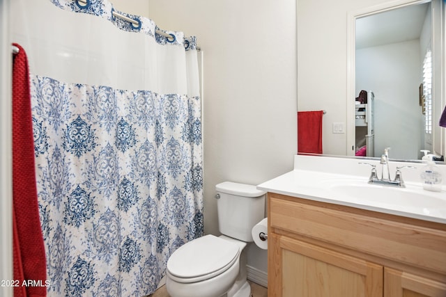 bathroom with walk in shower, vanity, and toilet