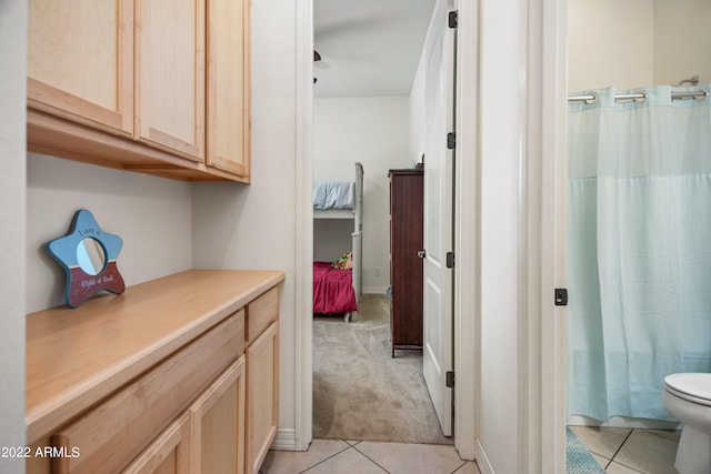 interior space featuring vanity, toilet, and tile patterned floors