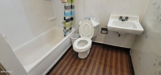 full bathroom featuring toilet, wood-type flooring, sink, and shower / bath combo with shower curtain