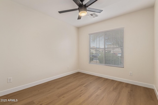 empty room featuring baseboards, visible vents, light wood finished floors, and ceiling fan