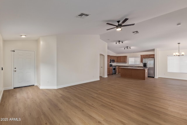 unfurnished living room with visible vents, light wood-style flooring, and ceiling fan with notable chandelier