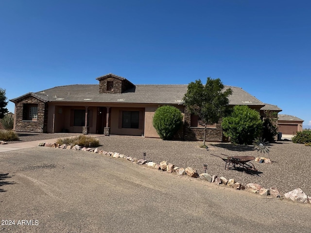 view of front of house featuring stone siding and stucco siding