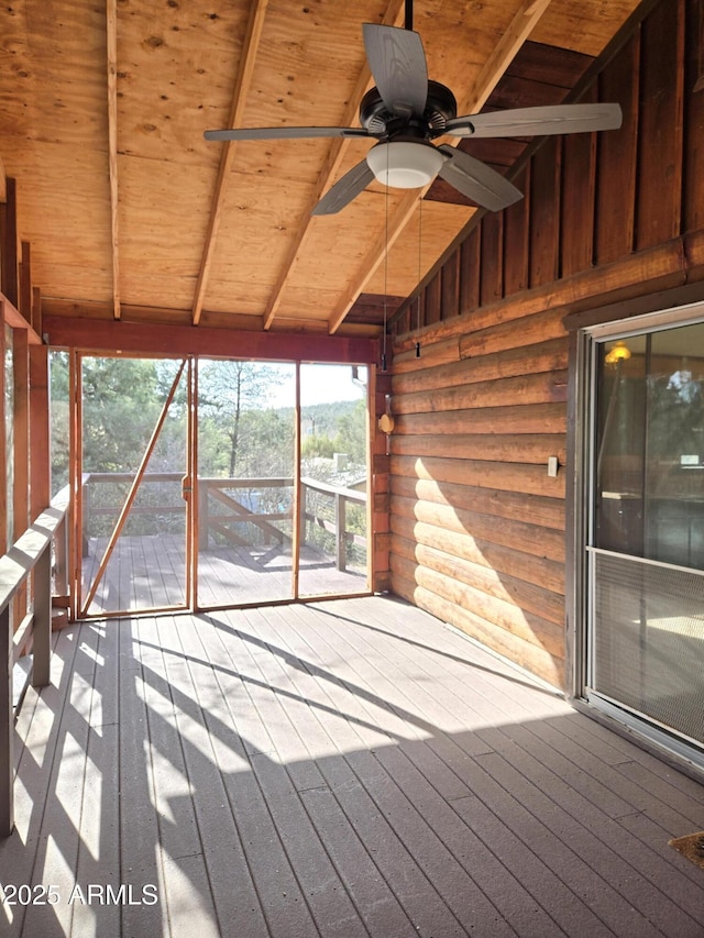 unfurnished sunroom featuring vaulted ceiling with beams, ceiling fan, and wood ceiling