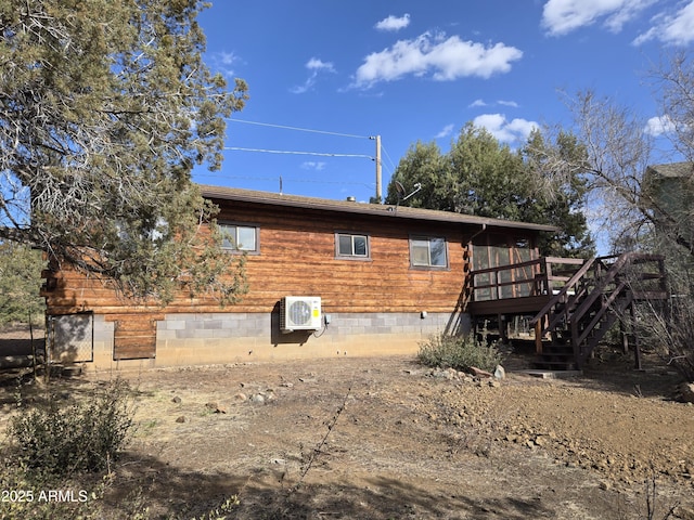 rear view of house with crawl space, ac unit, stairway, and a deck