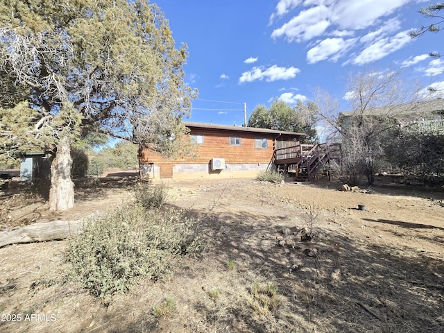 view of side of property featuring a deck and stairs