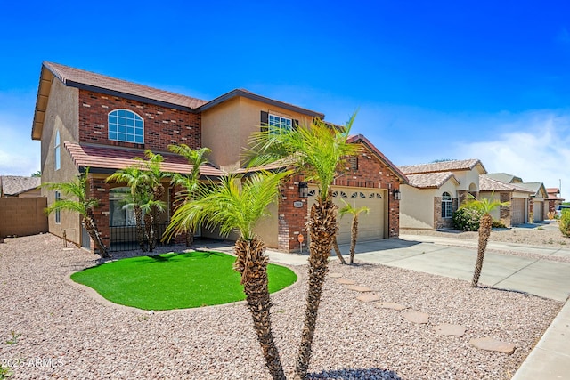 2909 W Bowker St, Phoenix, AZ 85041 - view of front of house featuring stucco siding, concrete driveway, a garage, brick siding, and fence