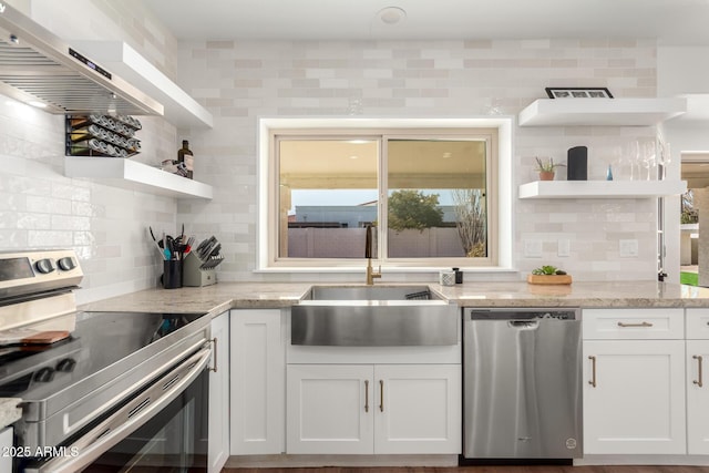 kitchen featuring sink, white cabinets, exhaust hood, stainless steel appliances, and light stone countertops