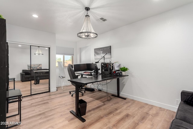 office space featuring hardwood / wood-style floors and an inviting chandelier