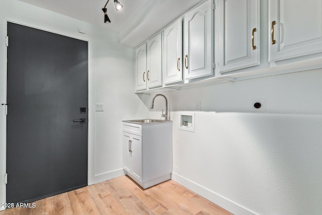 laundry area with sink, electric dryer hookup, hookup for a washing machine, cabinets, and light wood-type flooring