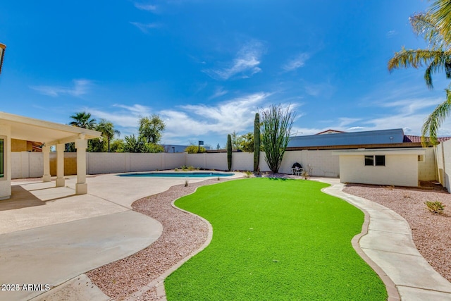 view of yard featuring a fenced in pool and a patio