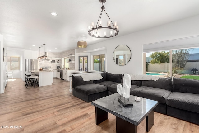 living room with a healthy amount of sunlight and light hardwood / wood-style floors