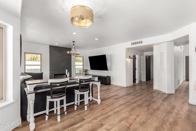 kitchen featuring hardwood / wood-style flooring and a breakfast bar area