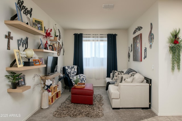 sitting room with visible vents and baseboards