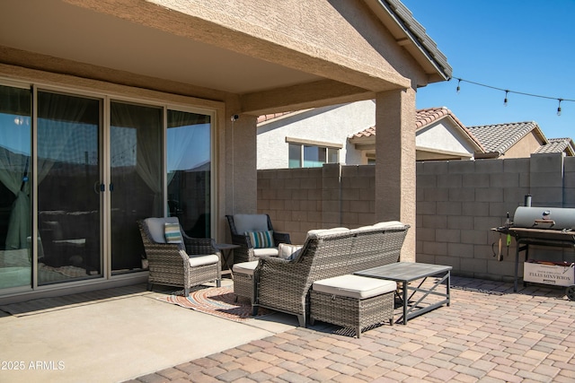 view of patio featuring area for grilling and fence