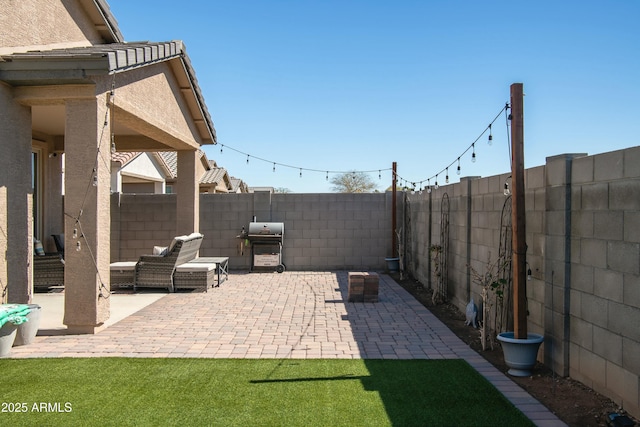 view of patio / terrace with a fenced backyard and a grill