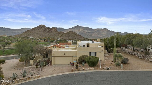 pueblo-style home with stucco siding